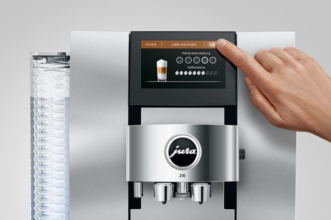 Person using the touchscreen of the Jura Z10 espresso machine